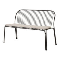 Black metal bench with a minimalist design and a neutral cream cushion. Ideal for modern outdoor decor.