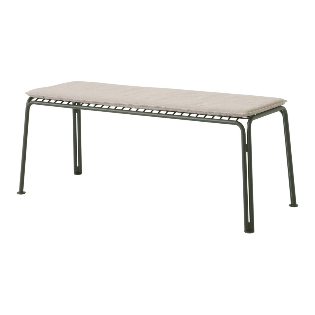 Neutral beige cushion on a dark green metal bench with minimalist design and clean lines.