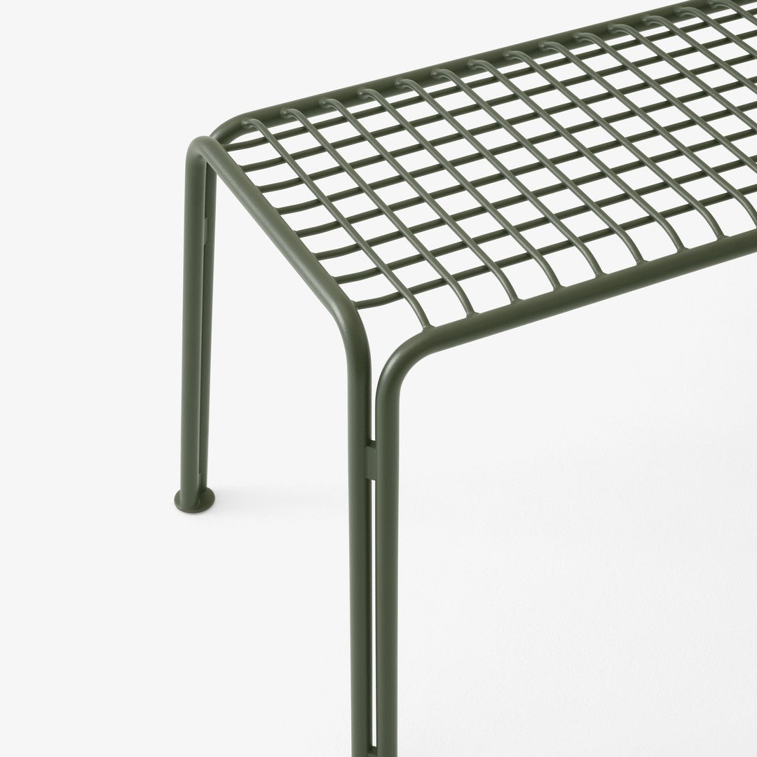 Green metallic bench with a geometric grid pattern and simple, minimalist design.