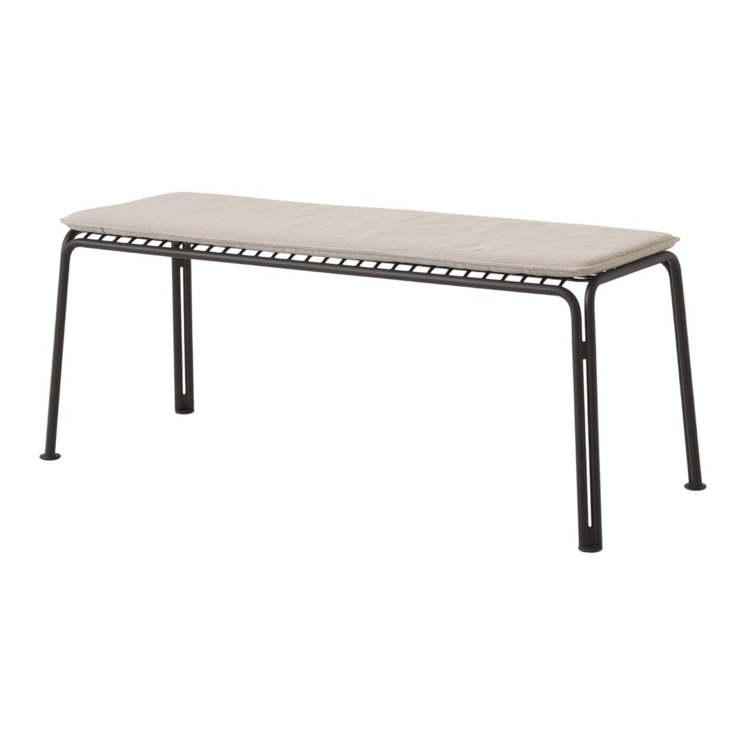 Modern black metal bench with a neutral beige cushion, featuring a sleek, minimalist design. Perfect for any decor.