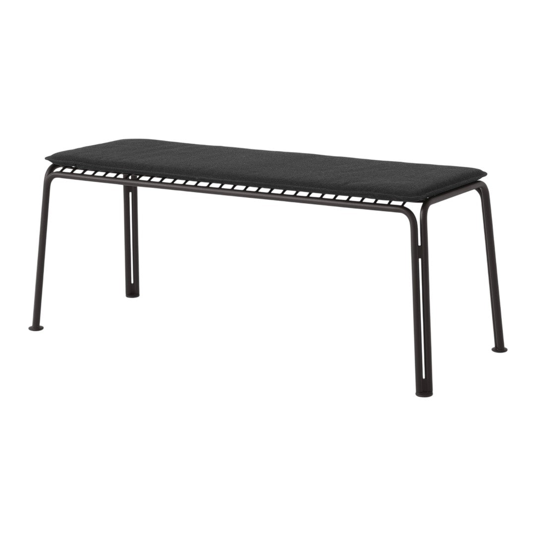 Black metal bench with a sleek, minimalist design and a solid surface, featuring subtle cut-out patterns along the edges.