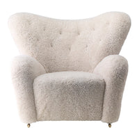 Cream-colored plush armchair with a soft, textured surface and curved silhouette. Ideal for cozy interiors.