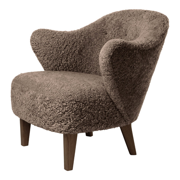 Cozy taupe chair with soft, textured fabric and warm wooden legs, perfect for modern interiors.