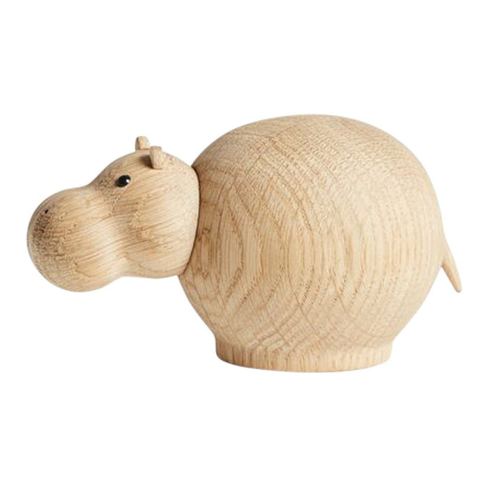 Natural wood hippo figurine with a smooth, light grain pattern, featuring a rounded body and minimalist design.