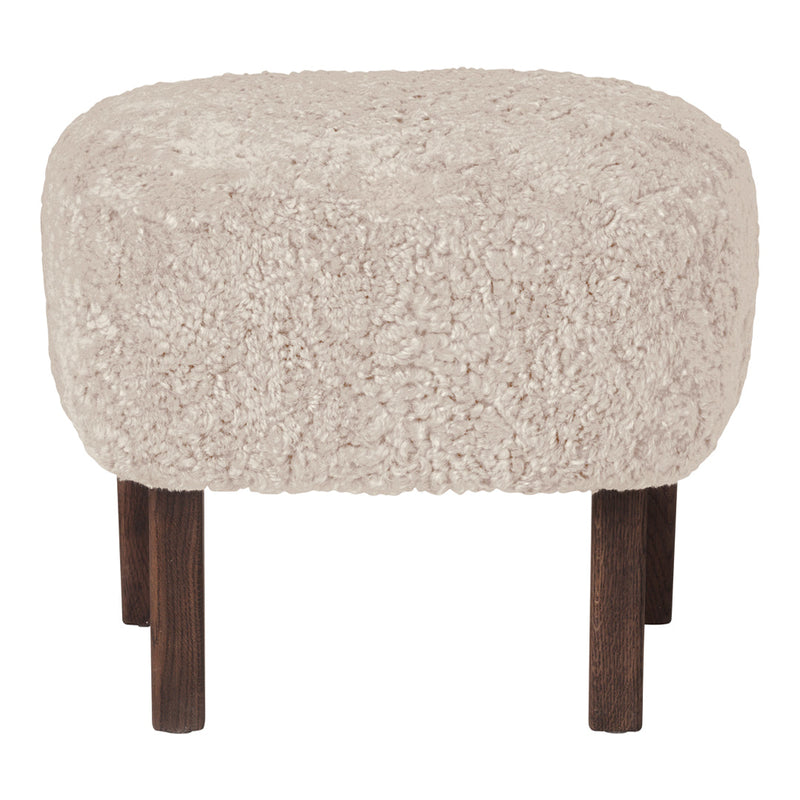 Textured beige ottoman with a fluffy surface and dark wooden legs, perfect for cozy decor.