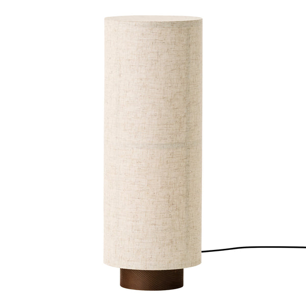 Beige cylindrical lamp with a textured fabric shade and a dark wooden base, perfect for modern decor.