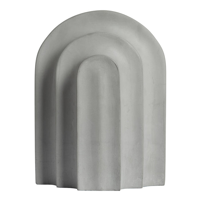 Gray arch-shaped sculpture with smooth curves and a minimalist design, featuring layered patterns.