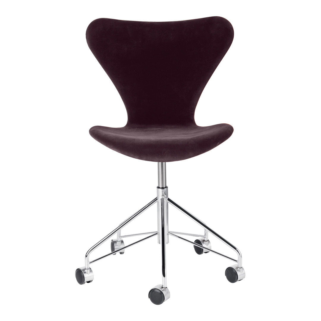Velvet burgundy swivel chair with a sleek chrome base and minimalist design, perfect for contemporary interiors.