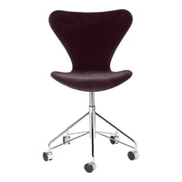 Velvet burgundy swivel chair with a sleek chrome base and minimalist design, perfect for contemporary interiors.