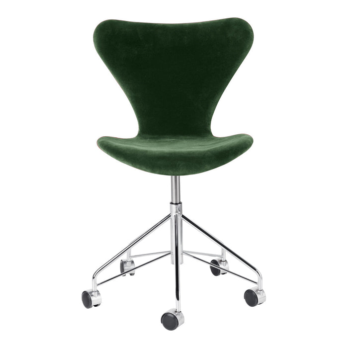 Green velvet swivel chair with a sleek chrome base and smooth lines, perfect for modern decor.