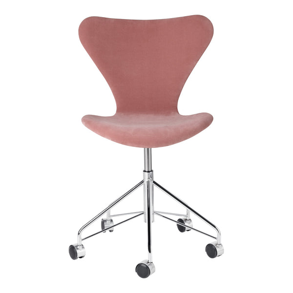 Pink velvet chair with a sleek curved design, featuring a chrome base and rolling wheels for easy mobility.