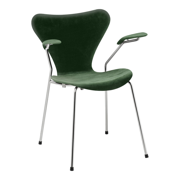 Green velvet chair with chrome accents and a unique butterfly silhouette. Modern design for stylish interiors.