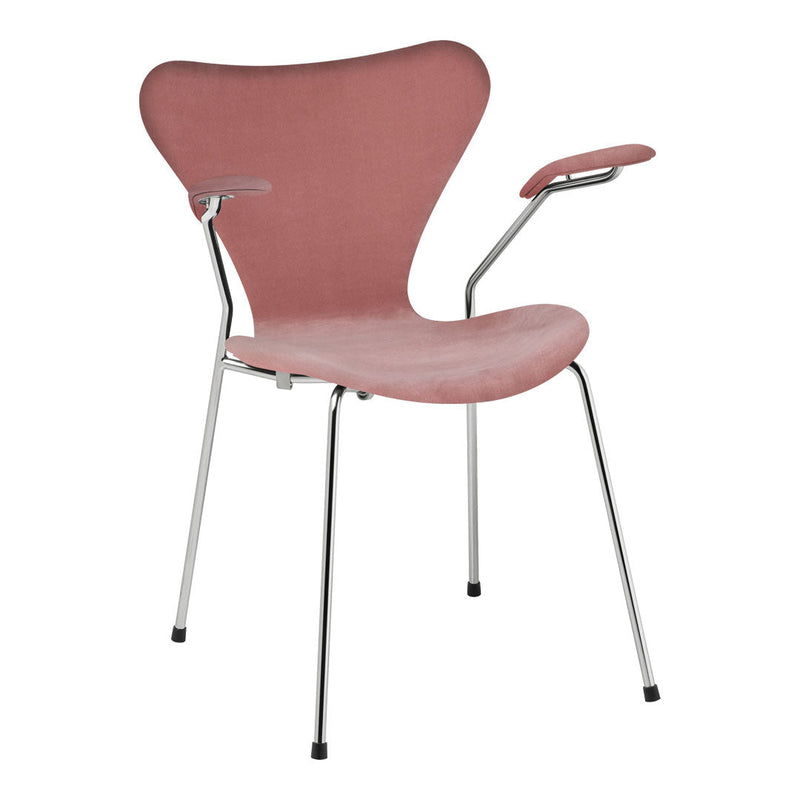 Stylish pink velvet chair with smooth curves and sleek chrome legs, perfect for modern decor.