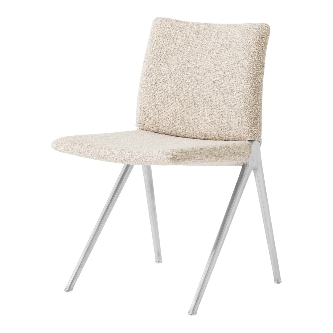 Beige upholstered chair with a smooth texture and sleek silver metal legs. Perfect for modern decor.