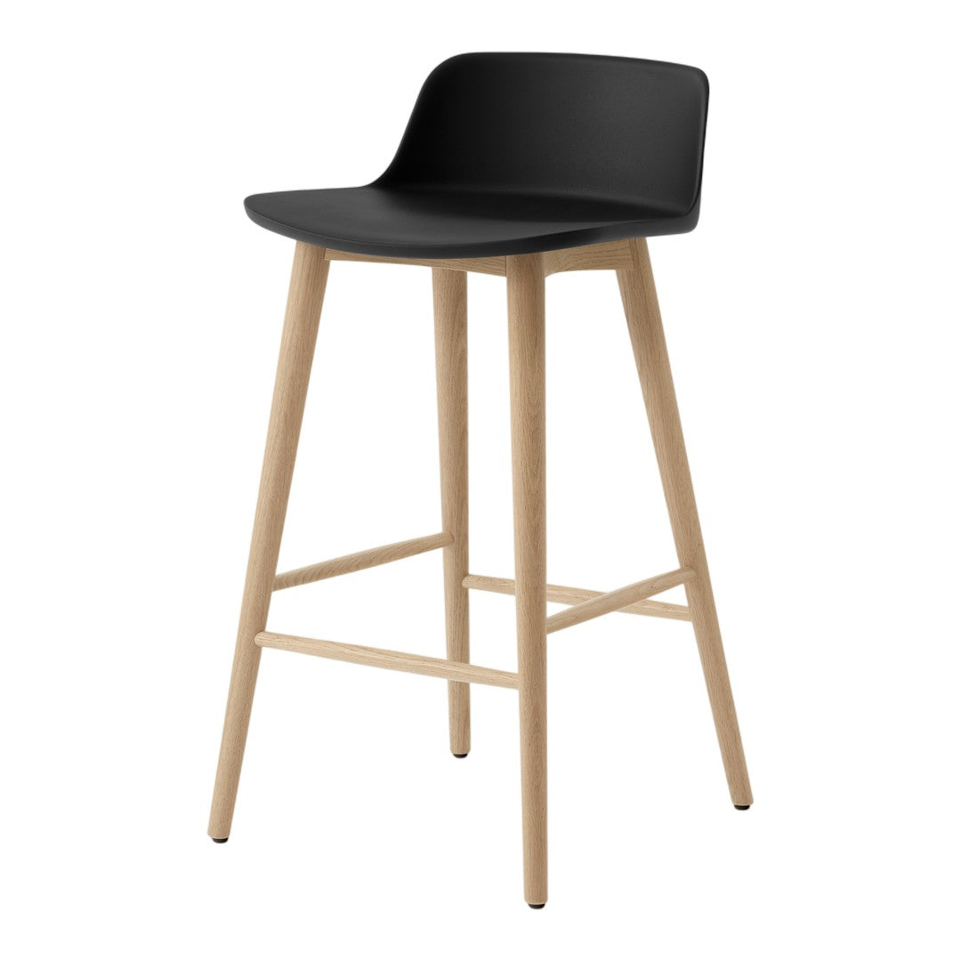 Black bar stool with a minimalist design and natural wood legs. Smooth curved seat adds modern elegance.