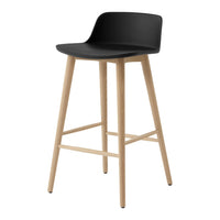 Black bar stool with a minimalist design and natural wood legs. Smooth curved seat adds modern elegance.