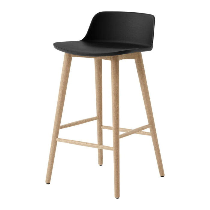Black bar stool with a minimalist design and natural wood legs. Smooth curved seat adds modern elegance.