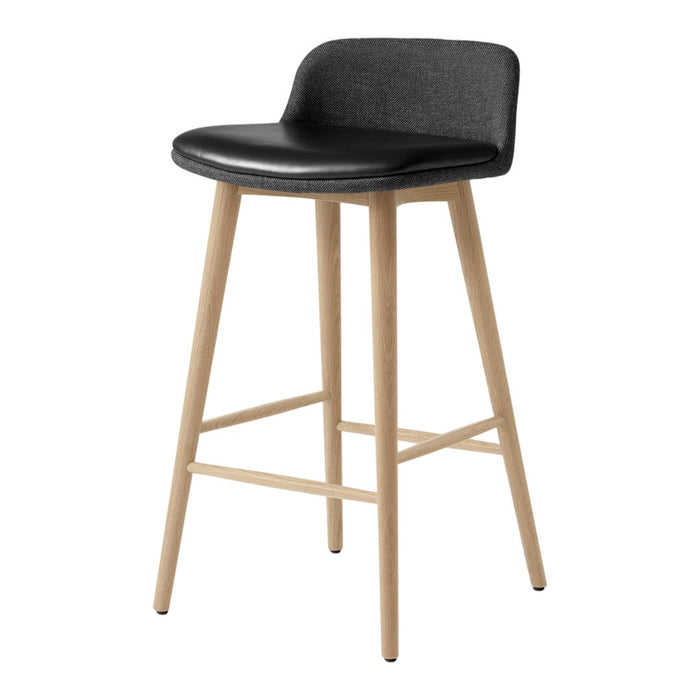 Black upholstered bar stool with light wood legs, featuring clean lines and a minimalist design.