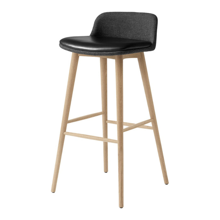 Black upholstered bar stool with natural wood legs, featuring a sleek, minimalist design.