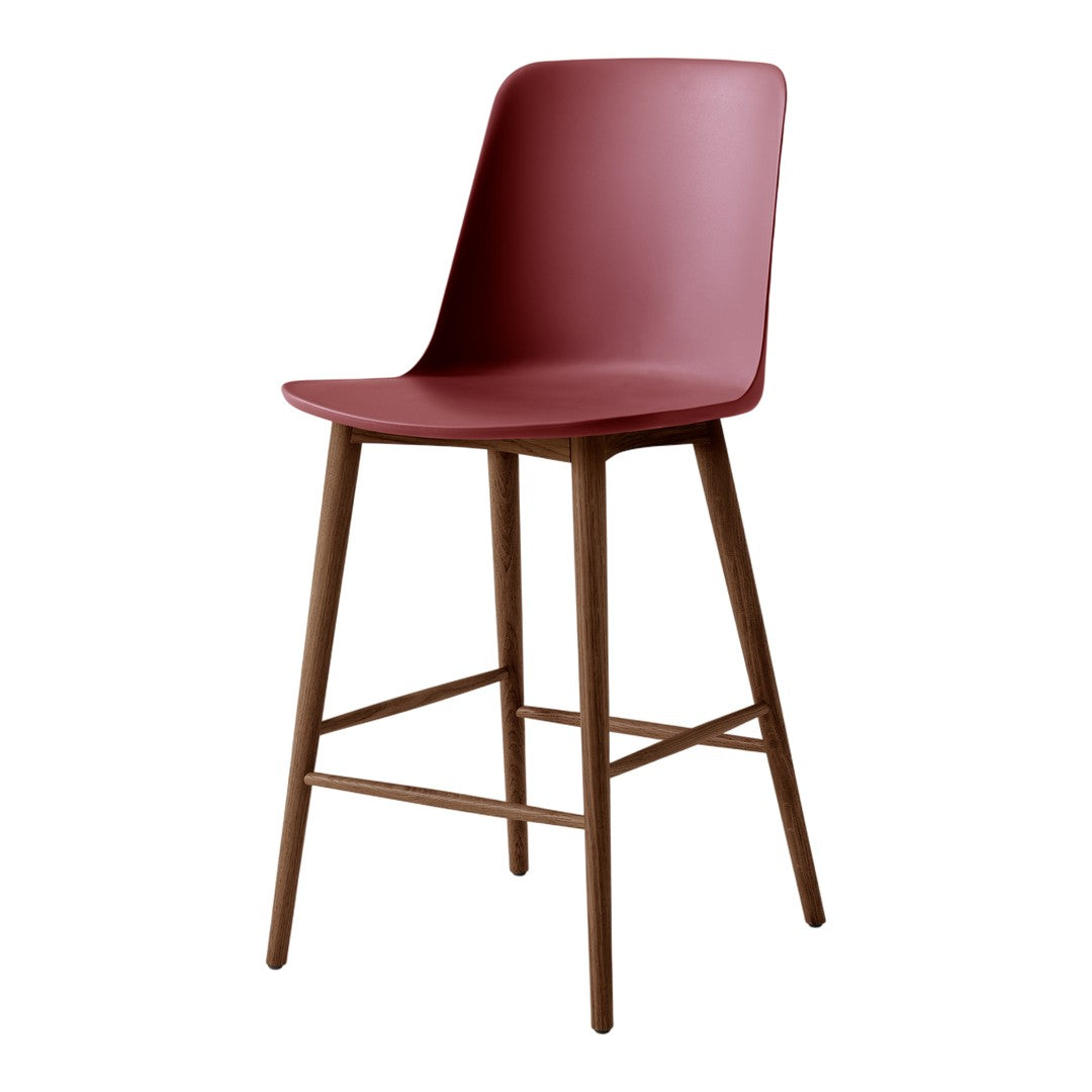 Modern burgundy bar stool with a sleek, solid seat and wooden legs, adding a pop of color to any space.