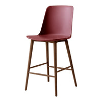 Modern burgundy bar stool with a sleek, solid seat and wooden legs, adding a pop of color to any space.