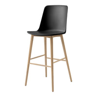 Black bar stool with a sleek, curved seat and natural wooden legs for a modern, minimalist look.