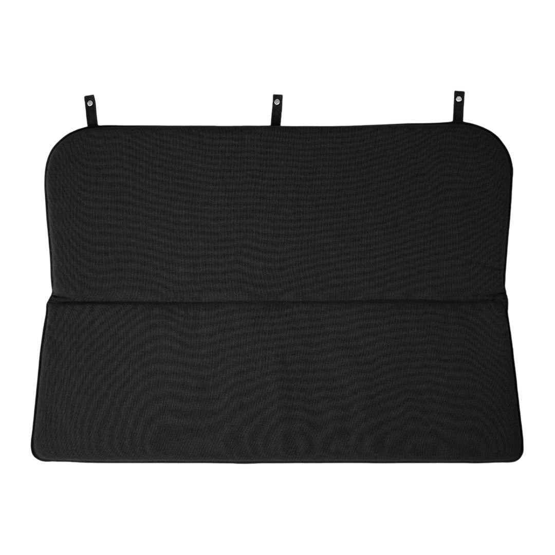 Black textured car backseat cover with smooth lines and subtle patterns. Versatile accessory for vehicle interiors.