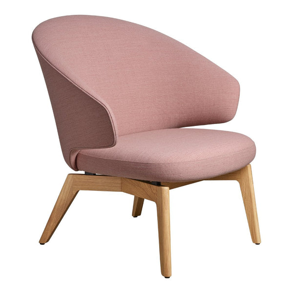 "Soft pink fabric accent chair with smooth curves and natural wood legs."