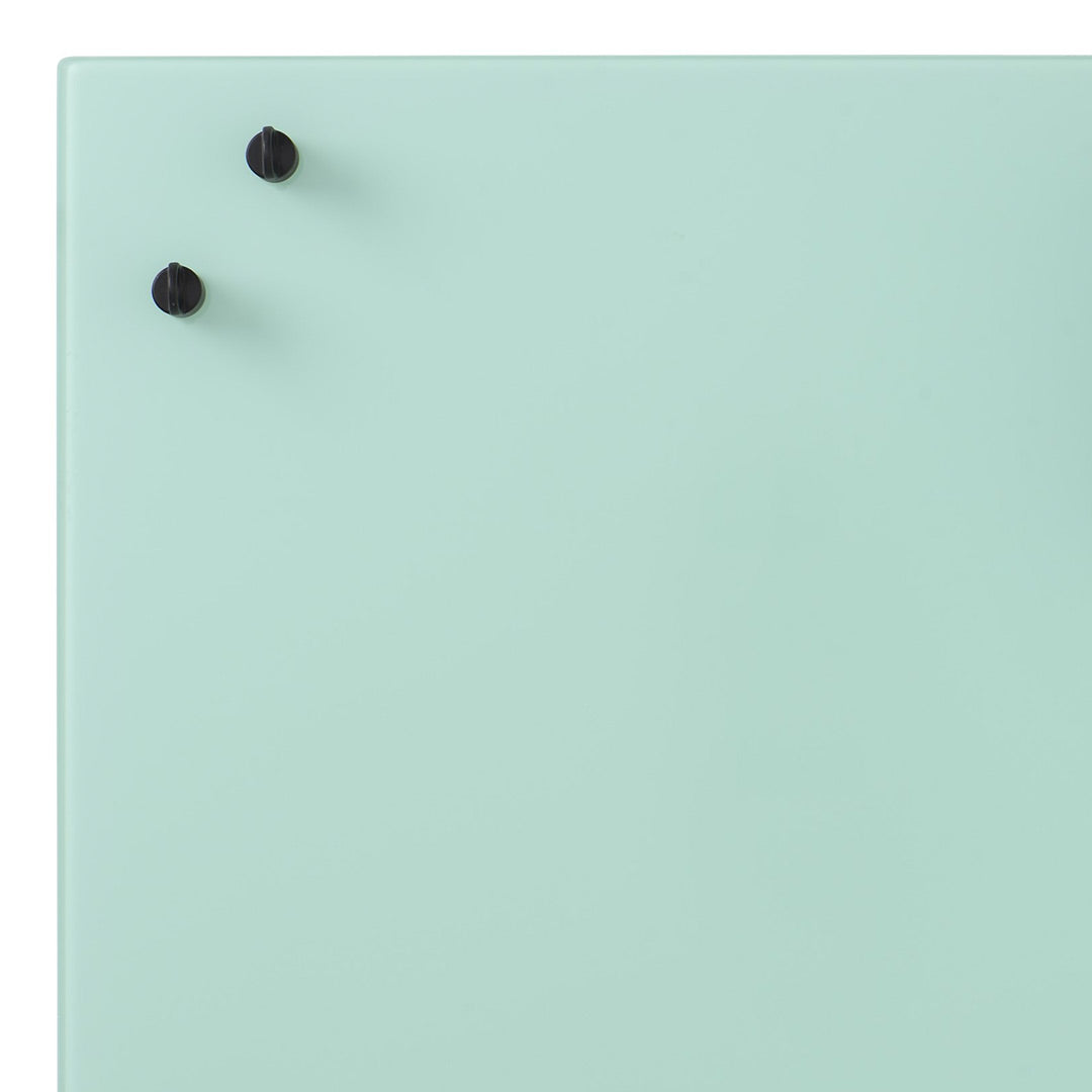 Mint green surface with two black pins, minimalistic design, ideal for modern spaces.