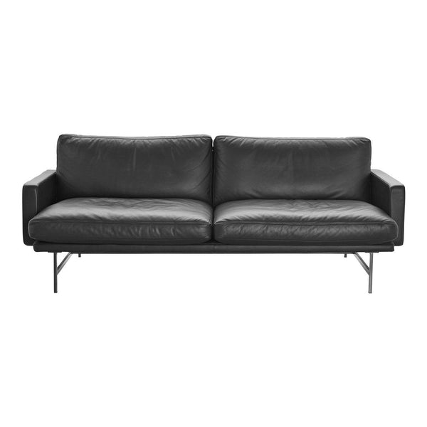 Modern black leather sofa with sleek lines and minimalistic design, featuring a smooth texture and neutral color palette.