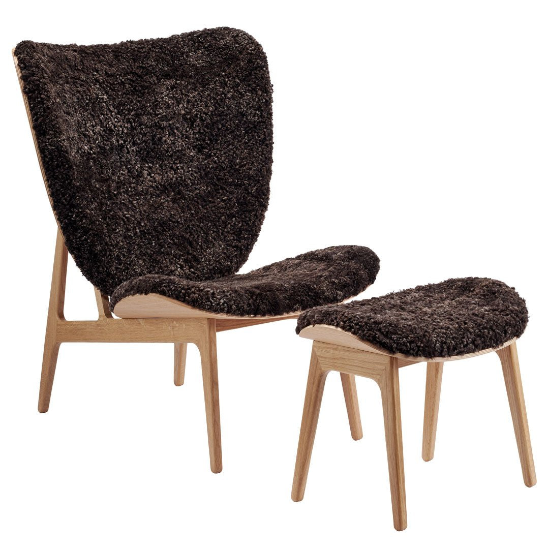 Cozy dark brown faux fur armchair and ottoman with natural wood legs, perfect for modern interiors.