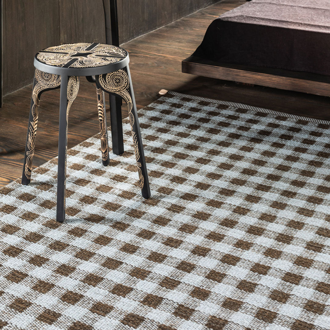 Brown and white checked pattern area rug, adding a cozy touch to modern decor. Perfect for any room setting.
