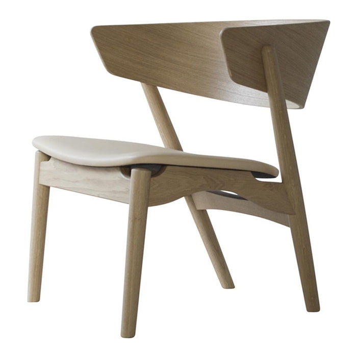 Light oak wood chair with a smooth white seat and a minimalist design, featuring clean lines and an angled backrest.