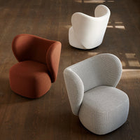 Three stylish accent chairs in rust, white, and gray, featuring smooth, modern curves and textured patterns.