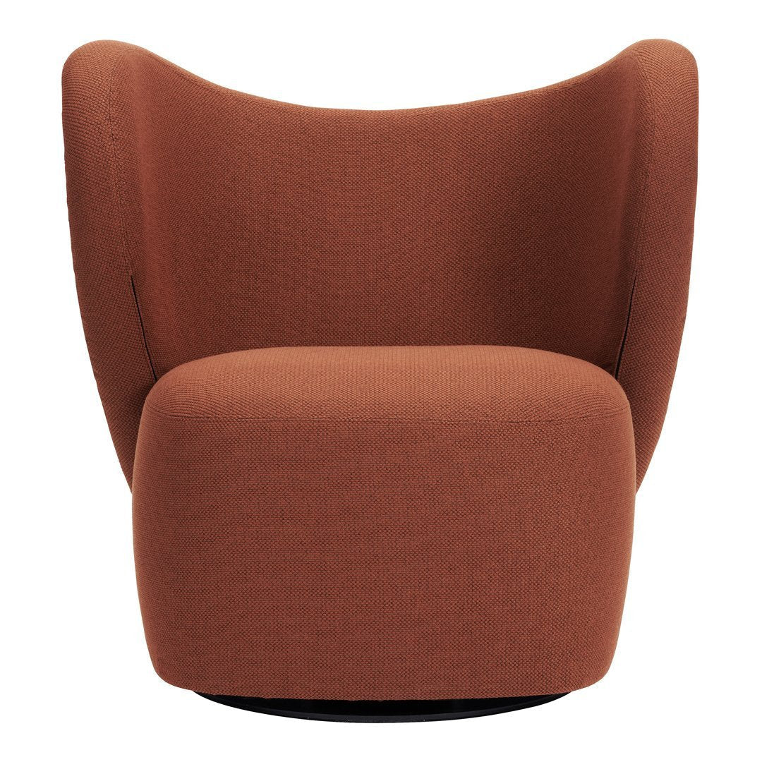 Rust-colored swivel chair with a smooth, modern upholstery and curvy, contoured design. Perfect for stylish living spaces.