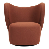 Rust-colored swivel chair with a smooth, modern upholstery and curvy, contoured design. Perfect for stylish living spaces.