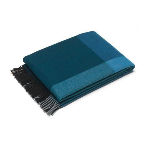 Teal plaid throw blanket with dark fringed edges, featuring varying shades of blue and green. Perfect for cozy decor.