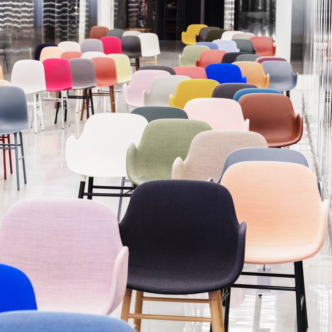 Colorful assortment of modern chairs in pastel, bold, and earthy tones with varied upholstery patterns.