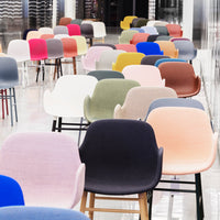 Colorful assortment of modern chairs in pastel, bold, and earthy tones with varied upholstery patterns.