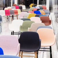 Colorful array of chairs featuring soft pastels and vibrant hues, with varied patterns and finishes.