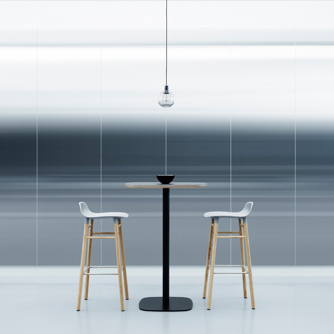 Modern bar table and stools with sleek wood and black accents against a gradient blue and gray patterned background.
