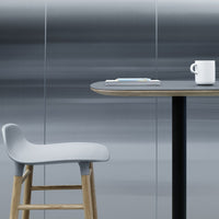Gray and silver tones with a sleek, modern table and a light gray chair, complemented by clean lines and minimalistic style.