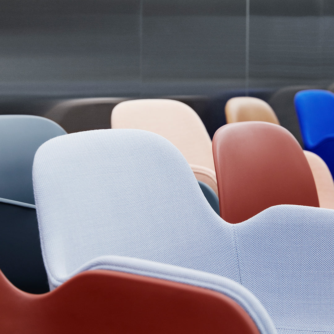 Colorful modern chairs in shades of blue, gray, peach, and red with smooth, minimalist patterns. Perfect for stylish decor.