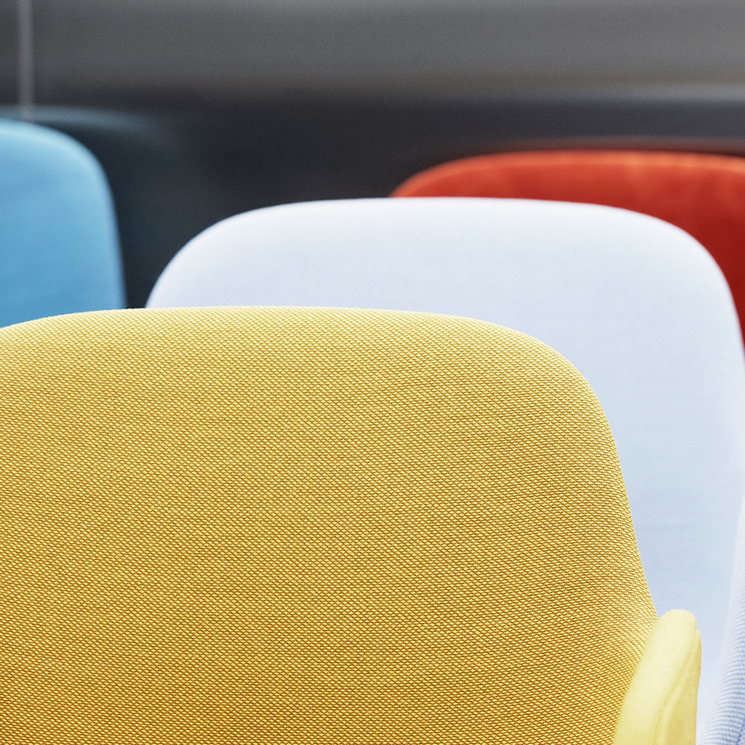 Colorful chair sections featuring yellow, white, blue, and red fabrics with a textured pattern.