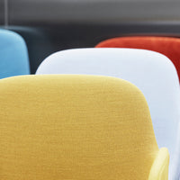 Colorful chair sections featuring yellow, white, blue, and red fabrics with a textured pattern.