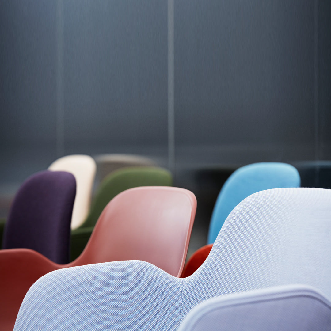 Colorful chairs in soft hues of purple, green, red, blue, and white with smooth, modern patterns.