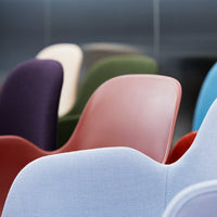 Colorful modern chairs in varying shades of purple, green, red, and blue with smooth, sleek finishes.