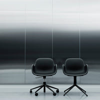 Two modern black office chairs with smooth, curved designs against a sleek, silver gradient background.