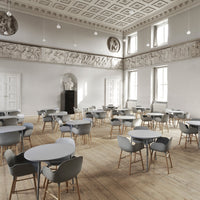 Gray chairs with light blue tabletops in an elegant, spacious room featuring intricate ceiling patterns.