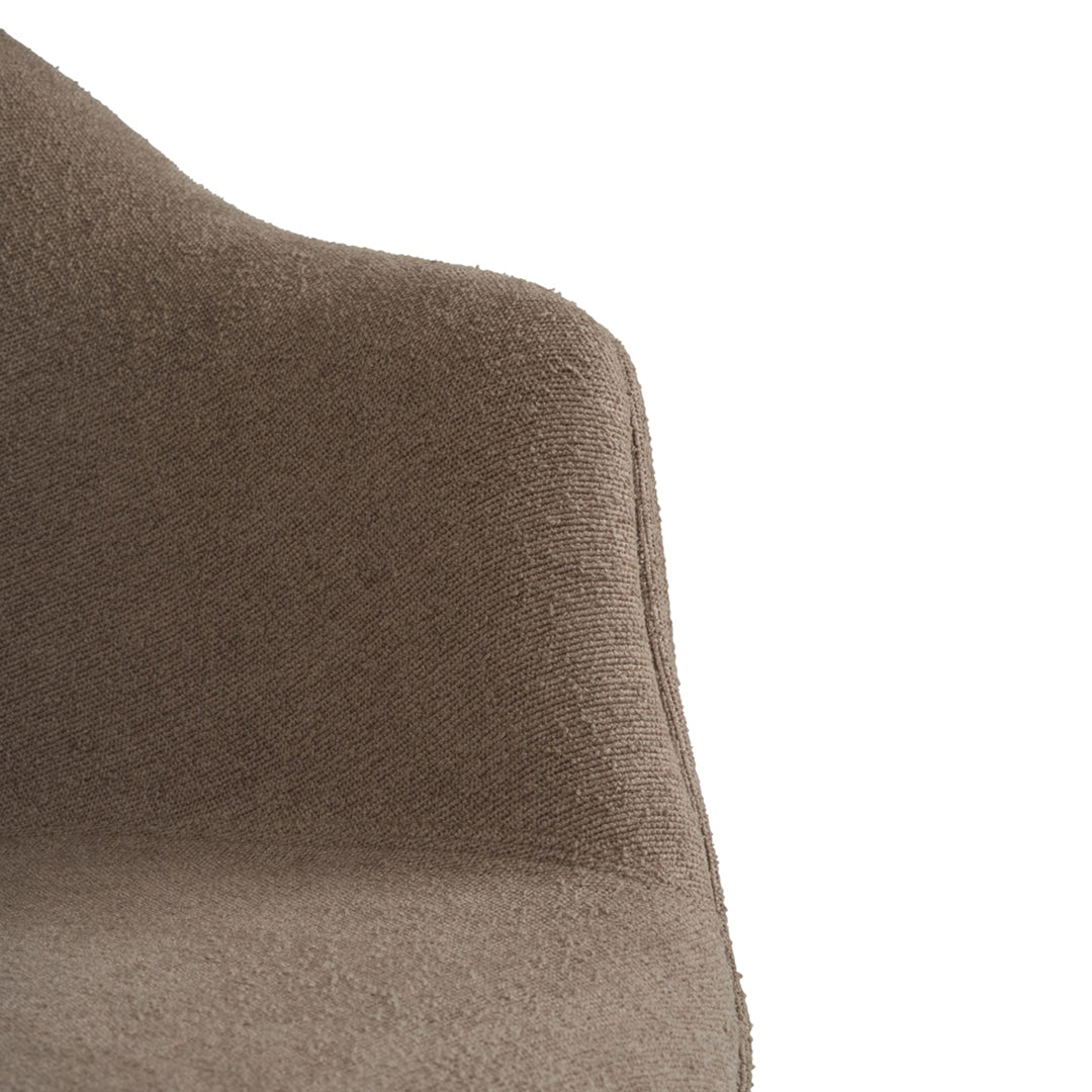 "Close-up of brown textured fabric upholstery on modern chair, showcasing a soft, muted color tone."